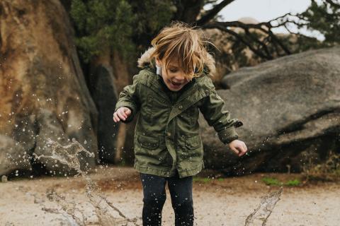 Child splashing on a puddle