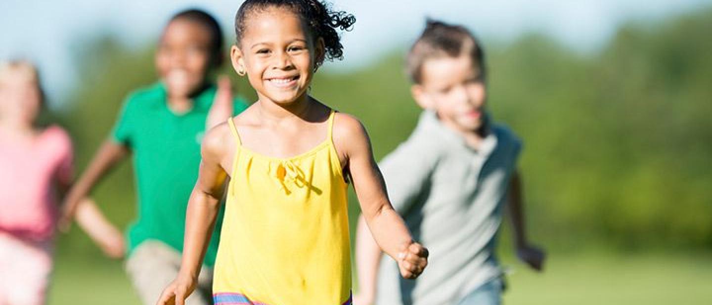 Children running and playing on a field